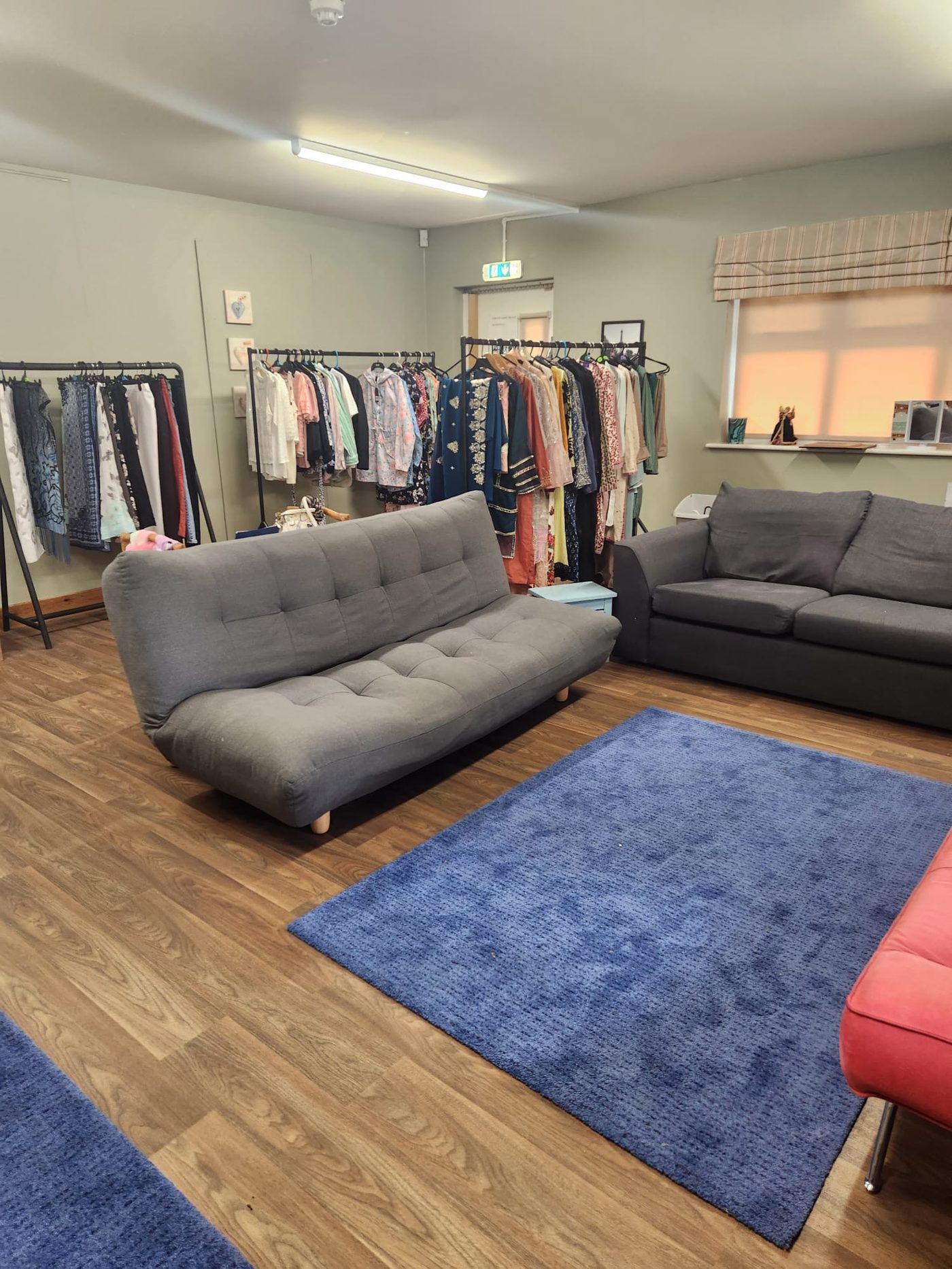 Clothing rails filled with donated dresses, tops and scarves at the WISE boutique